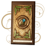A bronze casting medal on a wooden base