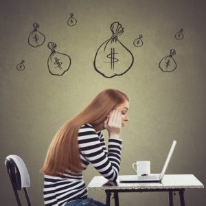 Upset businesswoman working on laptop